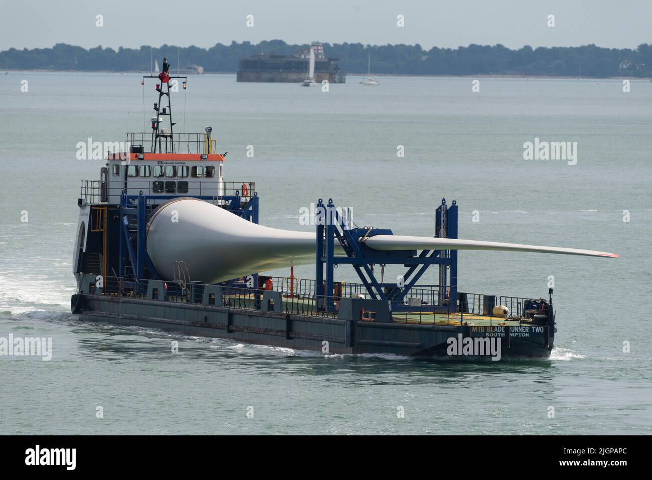 Portsmouth southern England UK. 2022. Wind turbine blade as cargo on Blade runner two  ship underway crossing The Solent bound for Portsmouth Harbour. Stock Photo