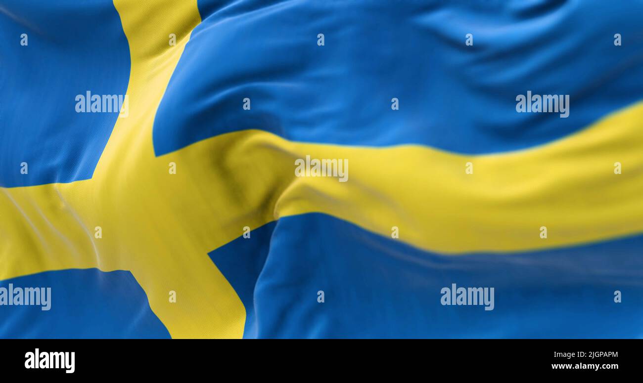 Close-up view of Sweden national flag waving in the wind. Scandinavian country located in northern Europe Stock Photo