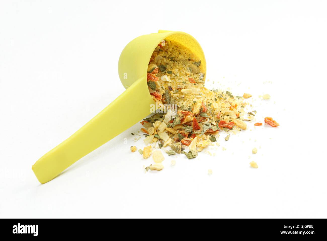 Plastic measuring spoon and mixture of spices isolated on white