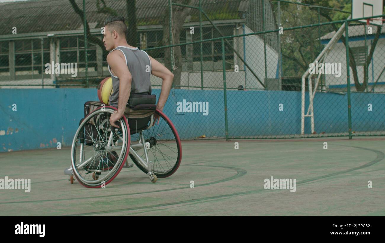 One paraplegic basketball player on wheelchair at basketball court