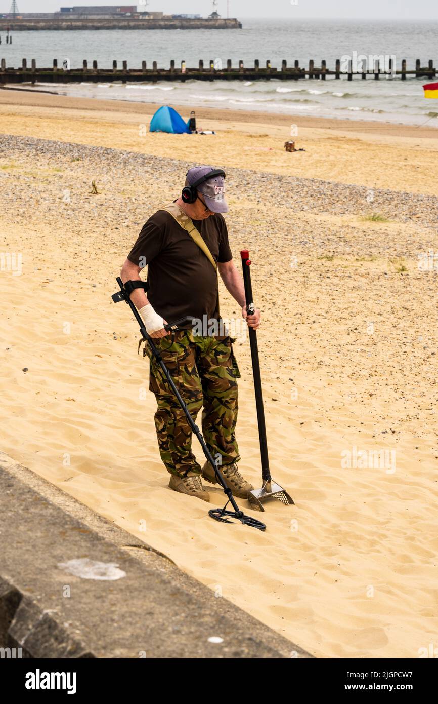 Man with metal detector on a beach in Norfolk Stock Photo Alamy