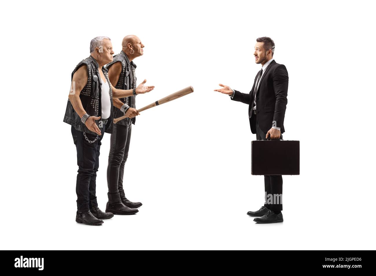 Full length profile shot of two angry punk men having an argument with a businessman isolated on white background Stock Photo