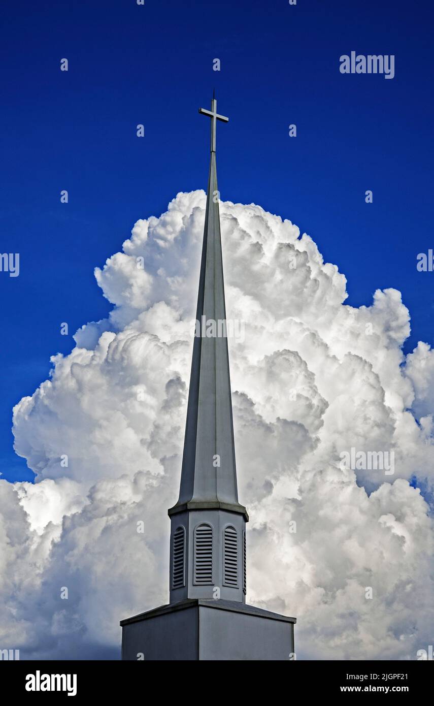 Beautiful clouds form a dramatic backdrop for a church steeple in North Central Florida. Stock Photo