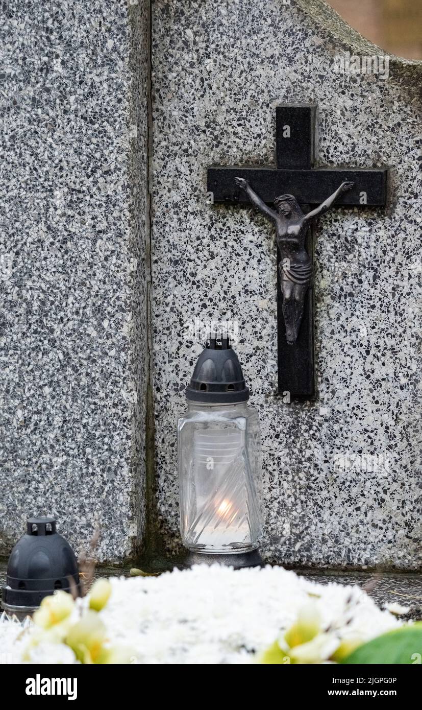 All Saints' Day and burning candles next to flowers on the graves