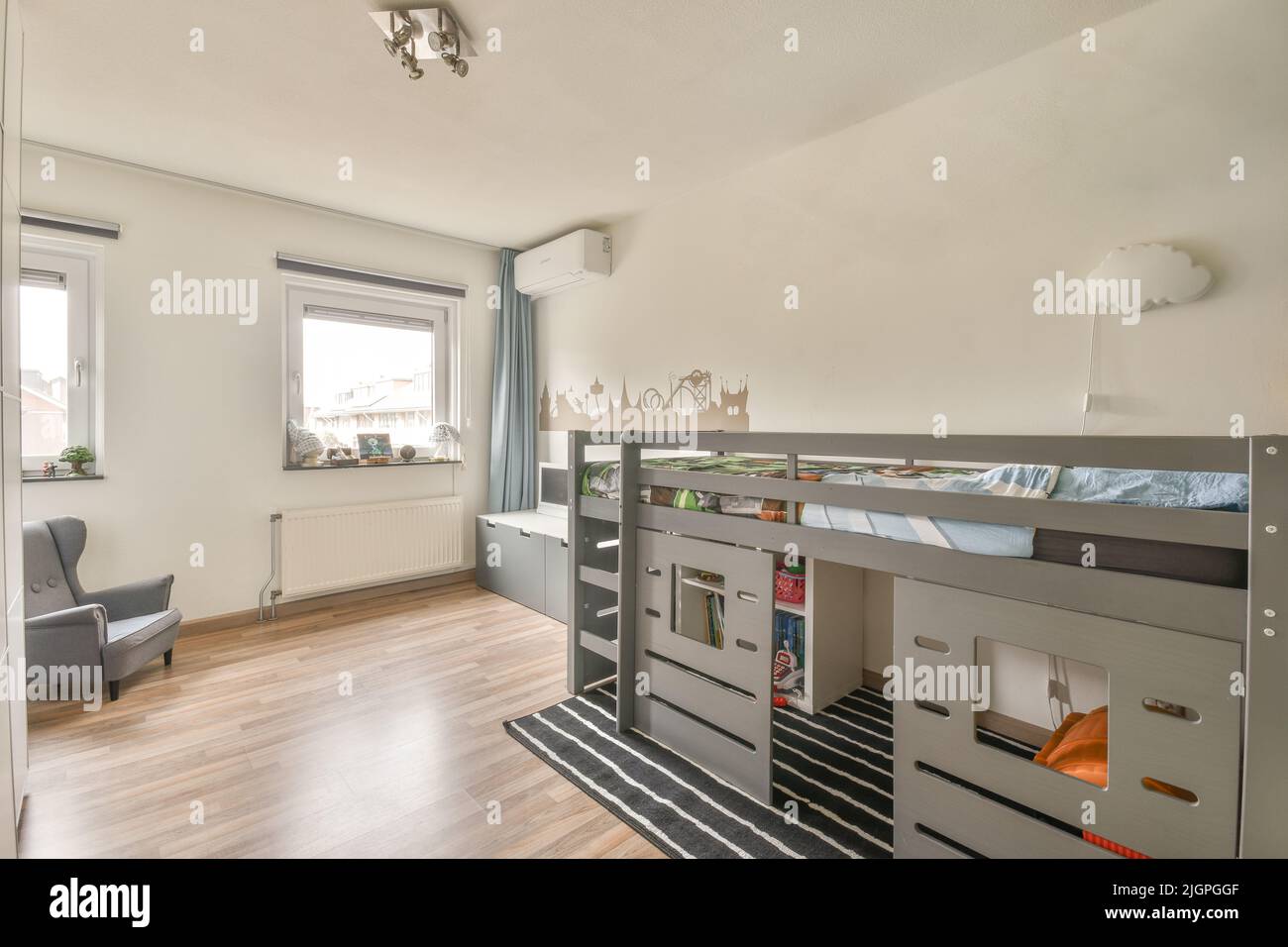 Interior of white room with baby crib and armchair near window with
