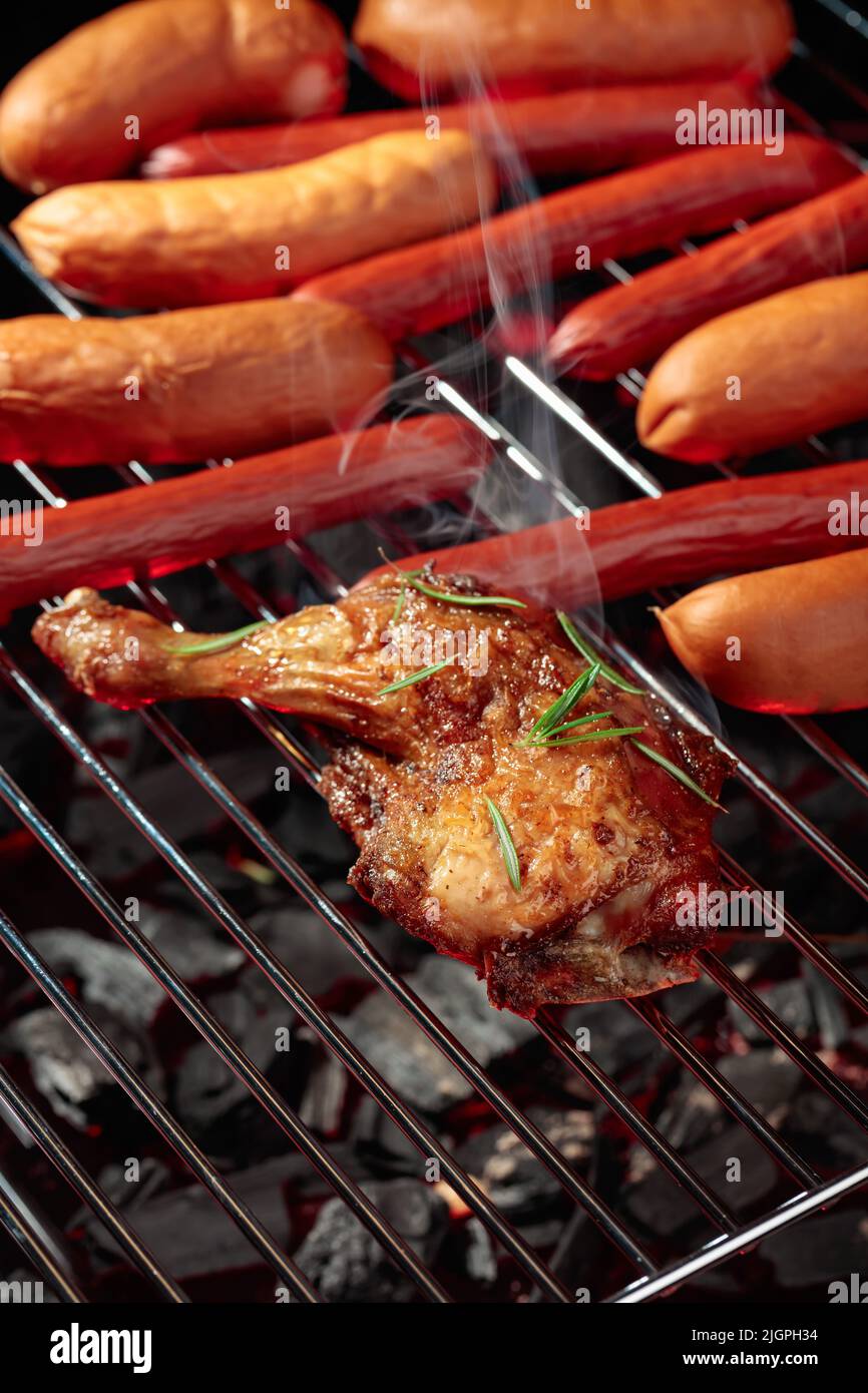 Chicken and sausages on a grill with smoke Stock Photo Alamy