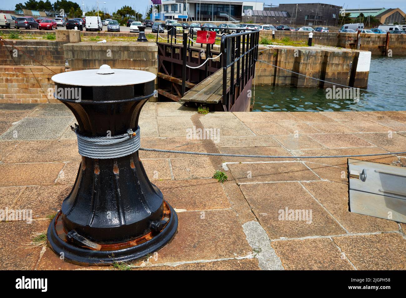 Image of dockside lock gate capstan with rusting cable Cherbourg, France Stock Photo