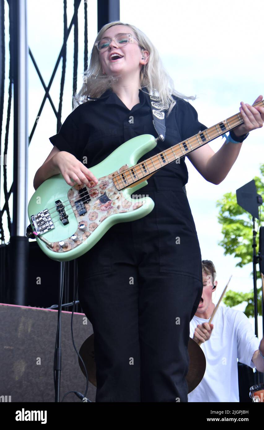 Bass guitarist Madeline Jarman is shown performing on stage during a