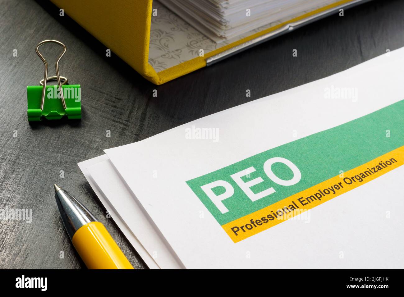 Papers about PEO professional employer organization and folder. Stock Photo