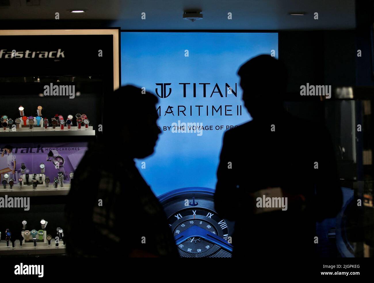 A salesperson speaks with a customer inside Titan World showroom in Ahmedabad, India, July 12, 2022. REUTERS/Amit Dave Stock Photo