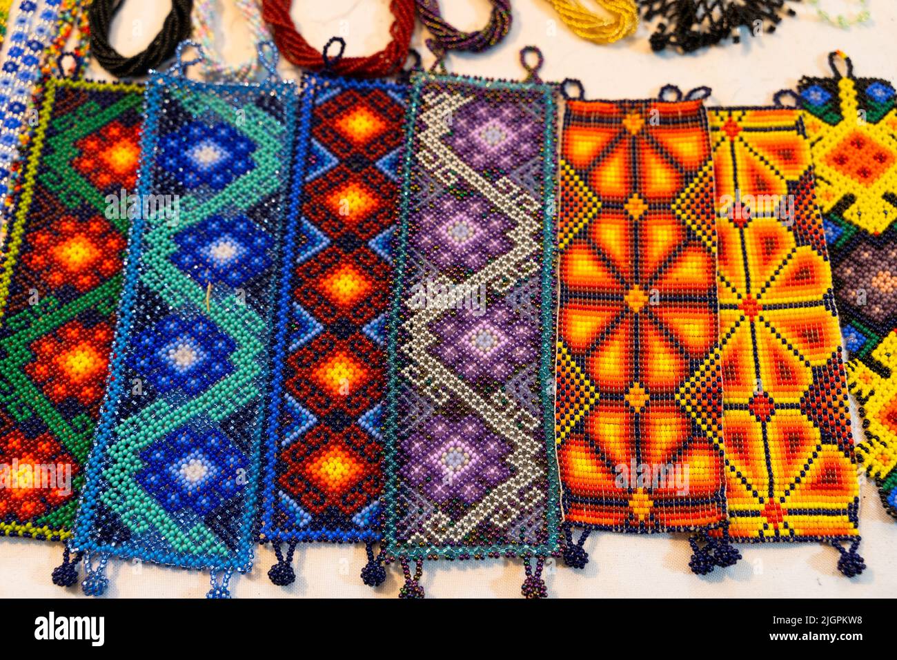 Handmade huichol bracelets with different colors and patterns at night