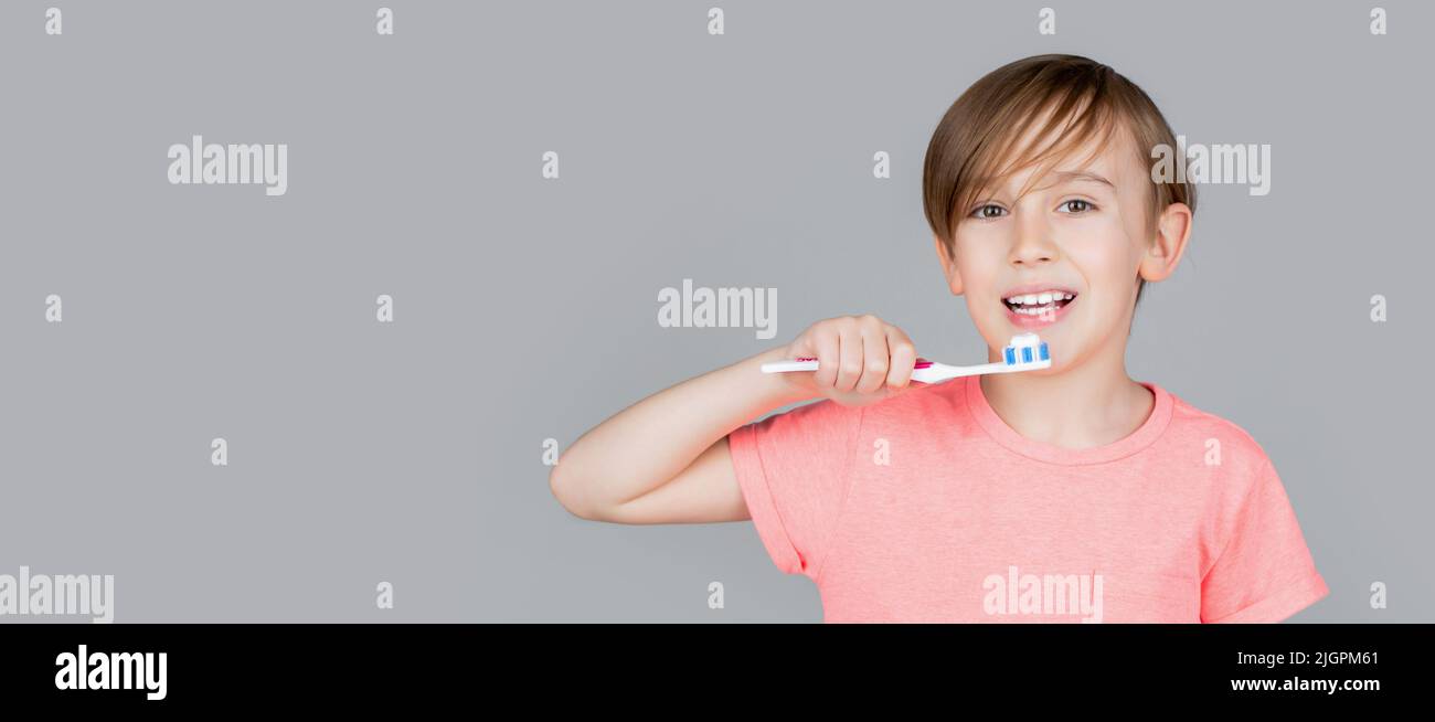 Dental hygiene. Happy little kid brushing her teeth. Kid boy brushing teeth. Boy toothbrush white toothpaste. Health care, dental hygiene Stock Photo