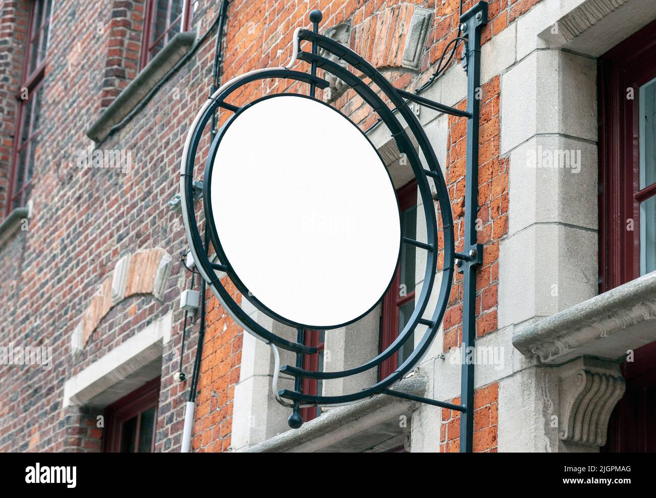 Circle mockup of street signboard on old brick wall, blank signage to add company or restaurant logo Stock Photo