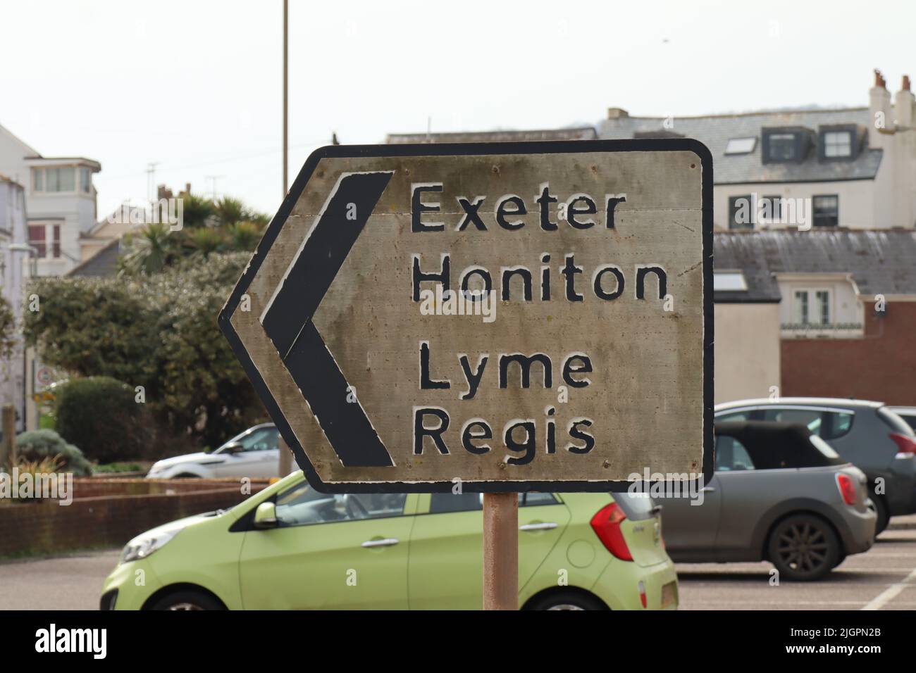 Dirty road sign by a car park in Sidmouth, Devon, pointing the way out