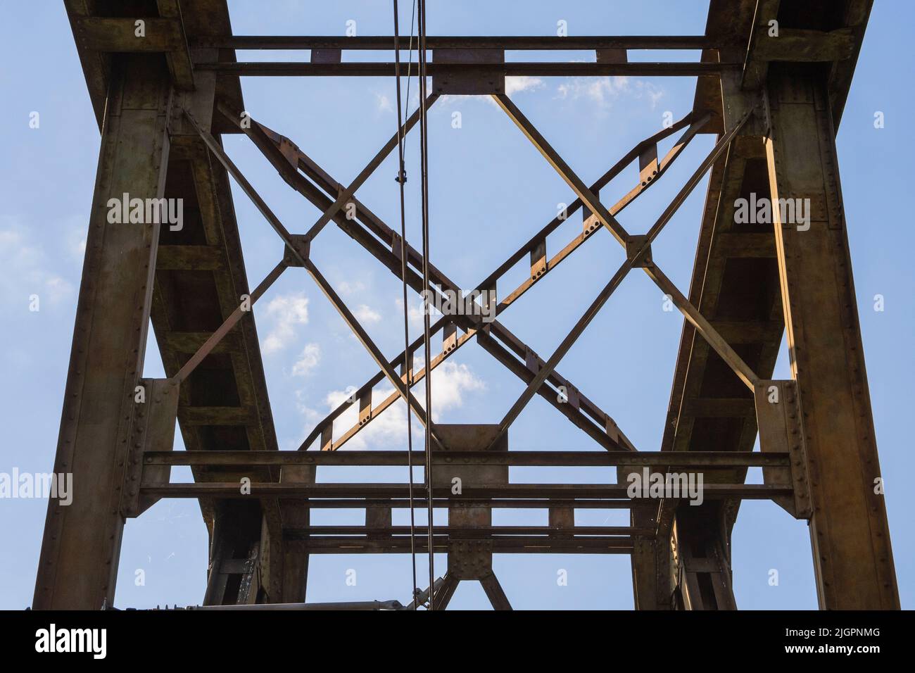 Railway viaduct against the sky and clouds in an unusual wide angle perspective. Stock Photo