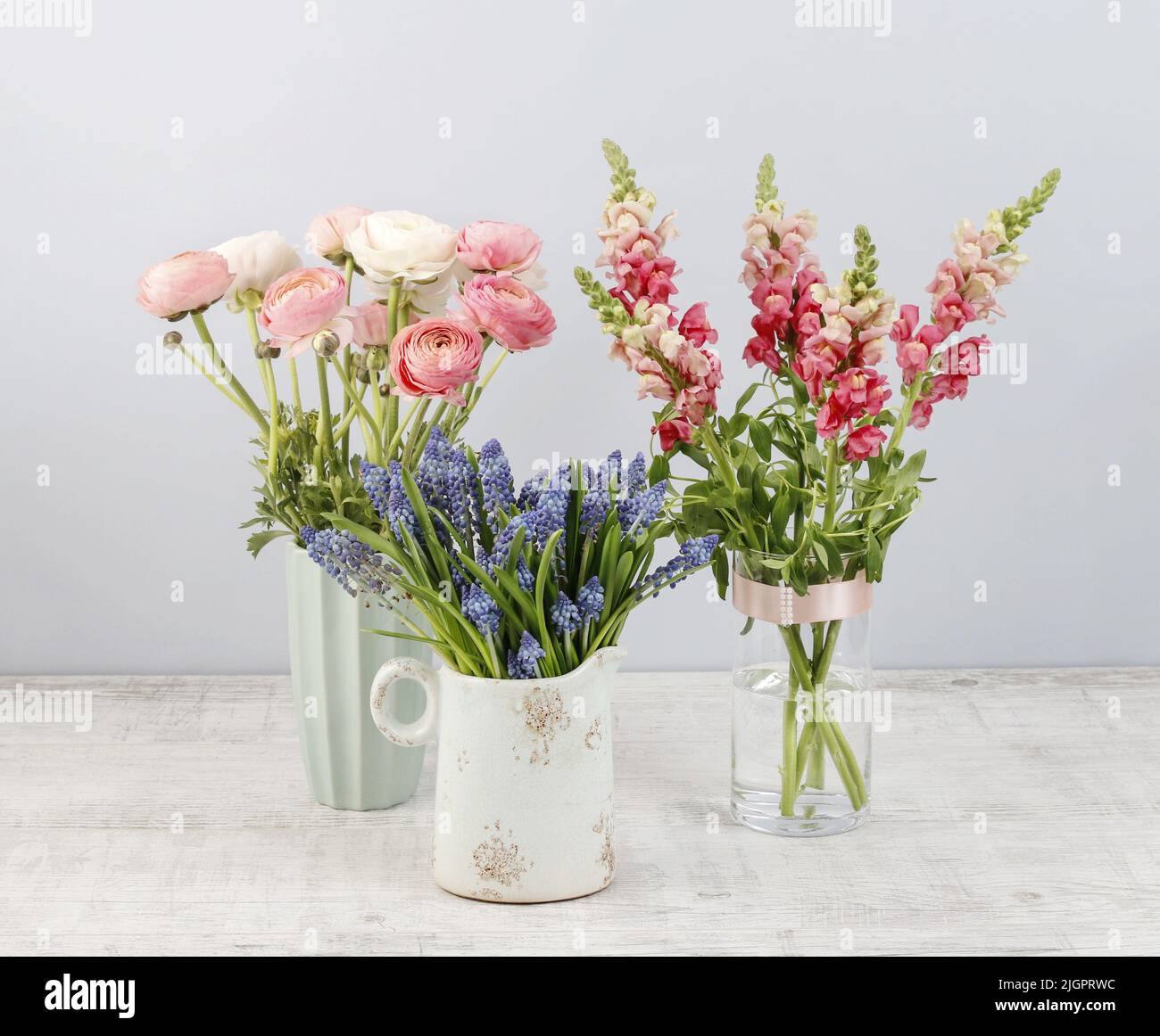 Beautiful muscari in ceramic jug and other spring flowers in the ...