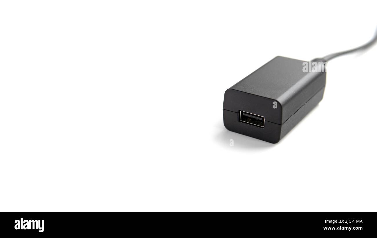 AC adapter with USB-port for devices isolated on white background with copy space.  Stock Photo