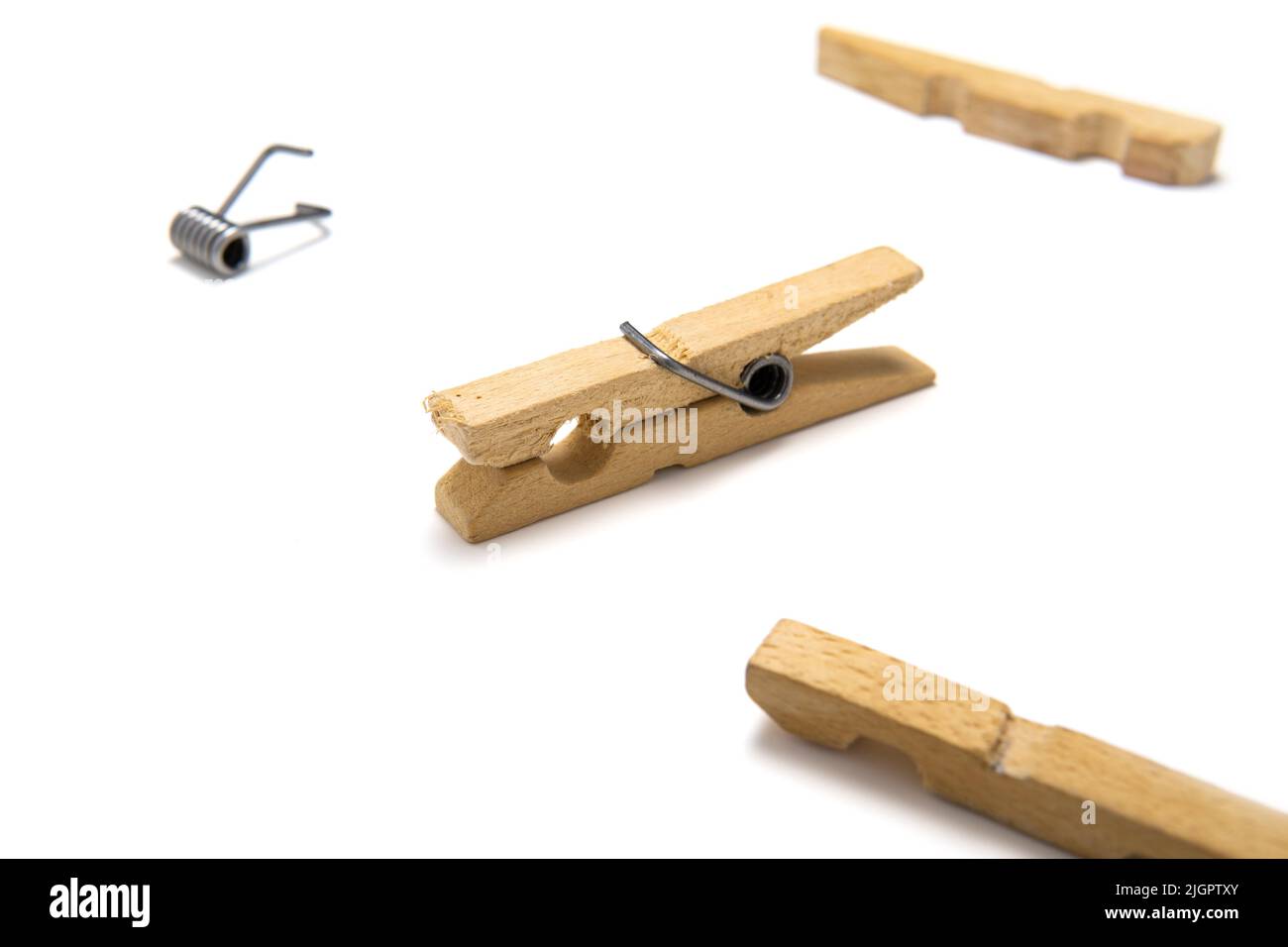 Wooden clothespin isolated on white background, surrounded by another