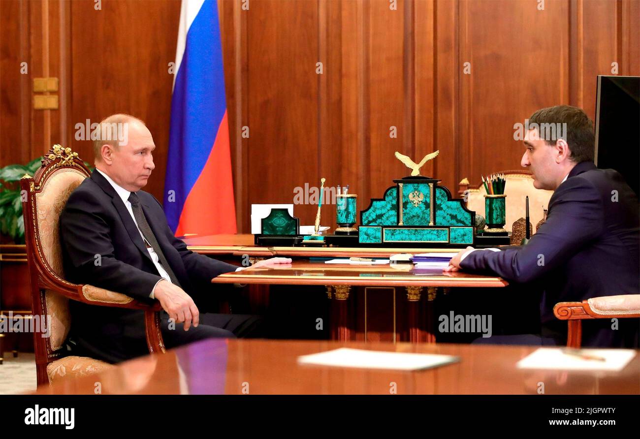 Moscow, Russia. 12th July, 2022. Russian President Vladimir Putin holds a face-to-face meeting with Andrei Ryumin, Chairman of the Management Board and Director General of the national power company Rosseti Group, right, at the Kremlin, July 12, 2022 in Moscow, Russia. Credit: Mikhail Klimentyev/Kremlin Pool/Alamy Live News Stock Photo