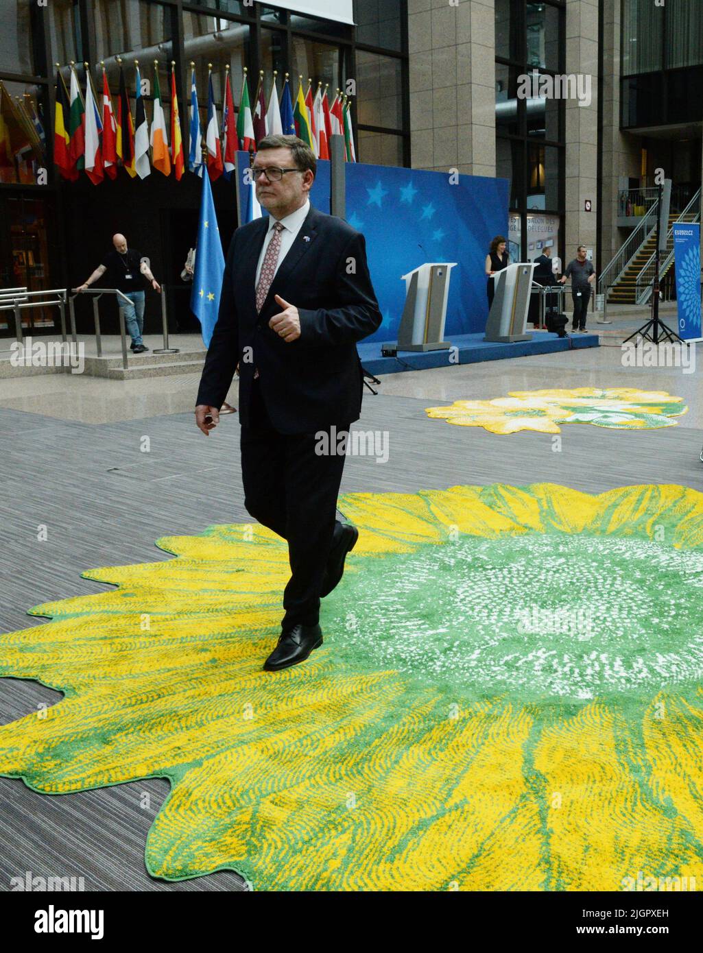 Brussels, Belgium. 12th July, 2022. Czech Republic's Finance Minister Zbynek Stanjura walks in the hall of the Justus Lipsius building in Brussels, Belgium, which was decorated with twelve carpets with floral motifs by Czech artists on the occasion of the Czech EU Presidency, July 12, 2022. Credit: Petr Kupec/CTK Photo/Alamy Live News Stock Photo