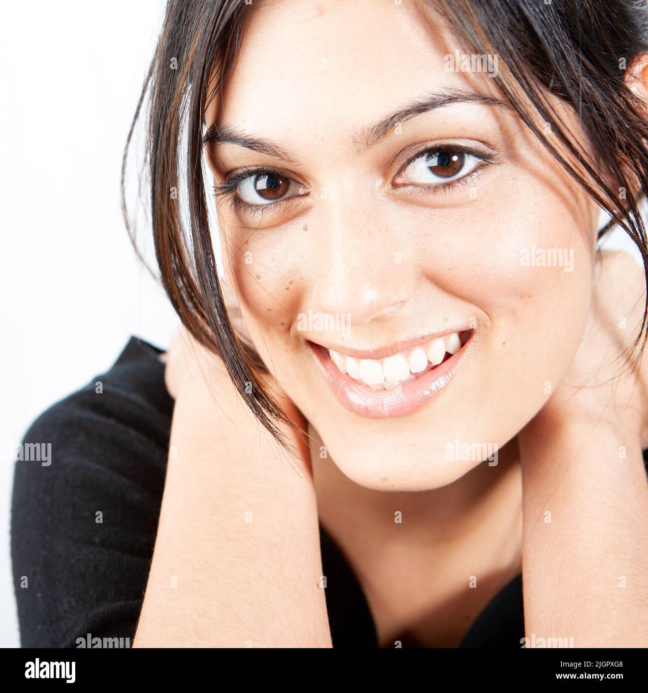 Natural Smile. A friendly close portrait of a beautiful young mixed ...