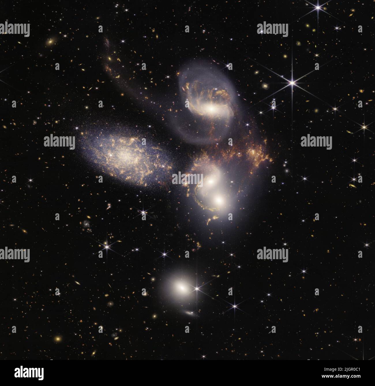 An enormous mosaic of Stephan's Quintet, released on July 12, 2022, is the largest image to date from NASA's James Webb Space Telescope, covering about one-fifth of the Moon's diameter. It contains over 150 million pixels and is constructed from almost 1,000 separate image files. The visual grouping of five galaxies was captured by Webb's Near-Infrared Camera (NIRCam) and Mid-Infrared Instrument (MIRI). This composite NIRCam-MIRI image uses two of the three MIRI filters to best show and differentiate the hot dust and structure within the galaxy. MIRI sees a distinct difference in color between Stock Photo