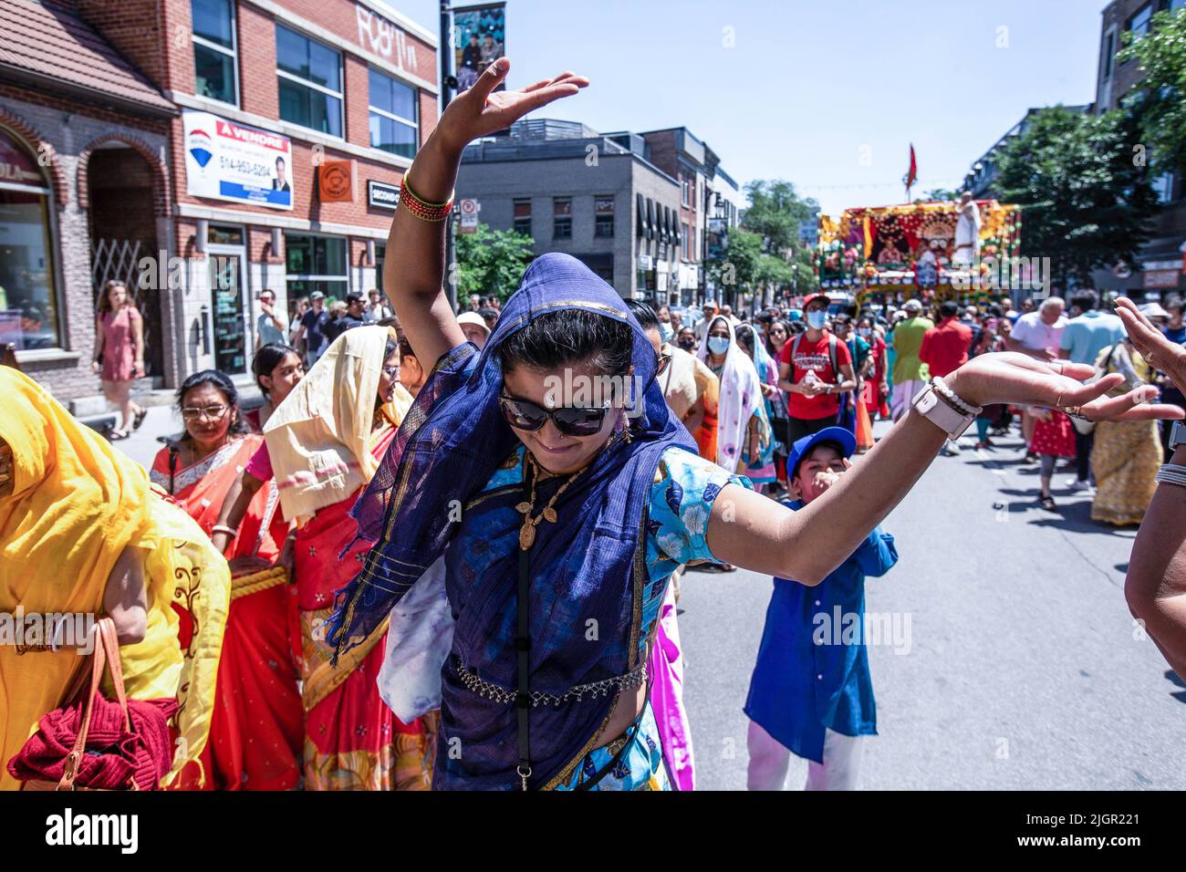A devotee dances during the celebration. Montrealers joined the Indian community for the Ratha Yatra parade, or the Hindu religious Chariot Festival in celebration of the deity Jagannath, the Lord of the Universe. The procession marched on Saint Laurent Boulevard pulling the main cart towards Jeanne Mance Park. Stock Photo