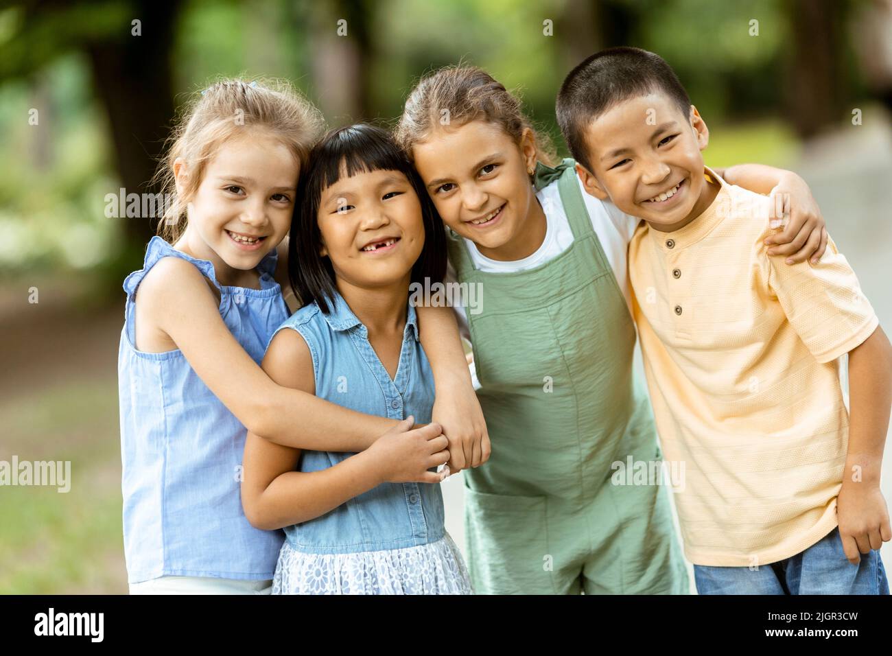 group-of-cute-asian-and-caucasian-kids-having-fun-in-the-park-stock