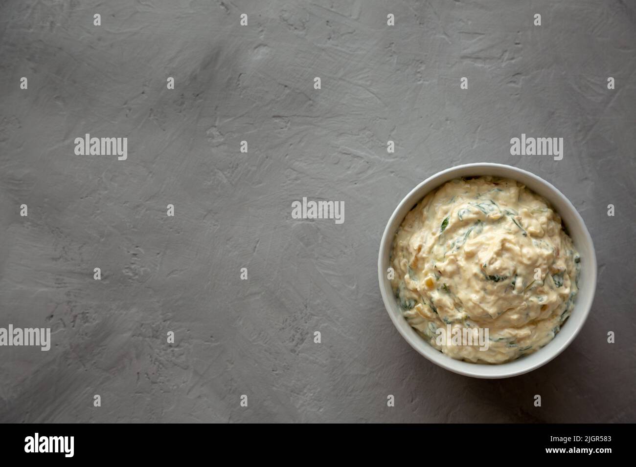 Homemade Caramelized Onion and Spinach Dip, top view. Flat lay ...
