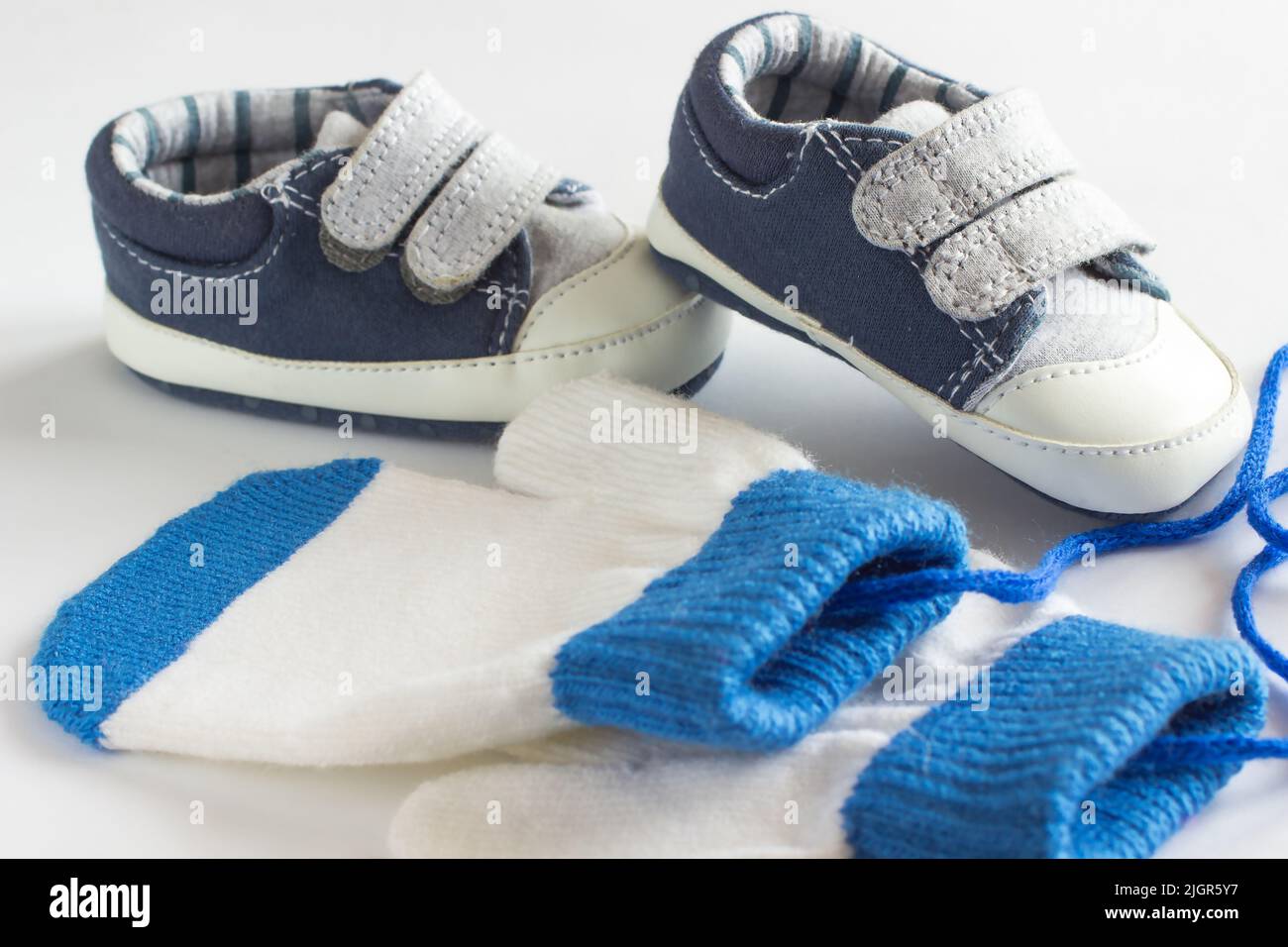 Children's shoes and mittens on a white background Stock Photo