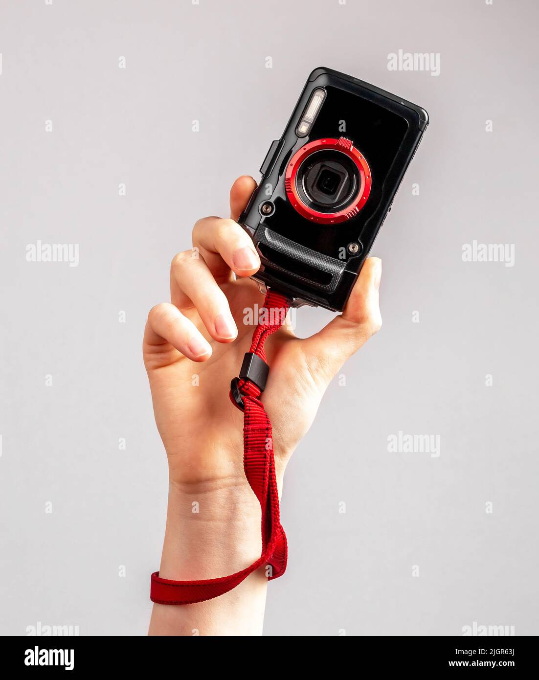Woman hand holding point and shoot camera. Practical and compact digital device for taking photos in travel. Tourist lifestyle. High quality photo Stock Photo