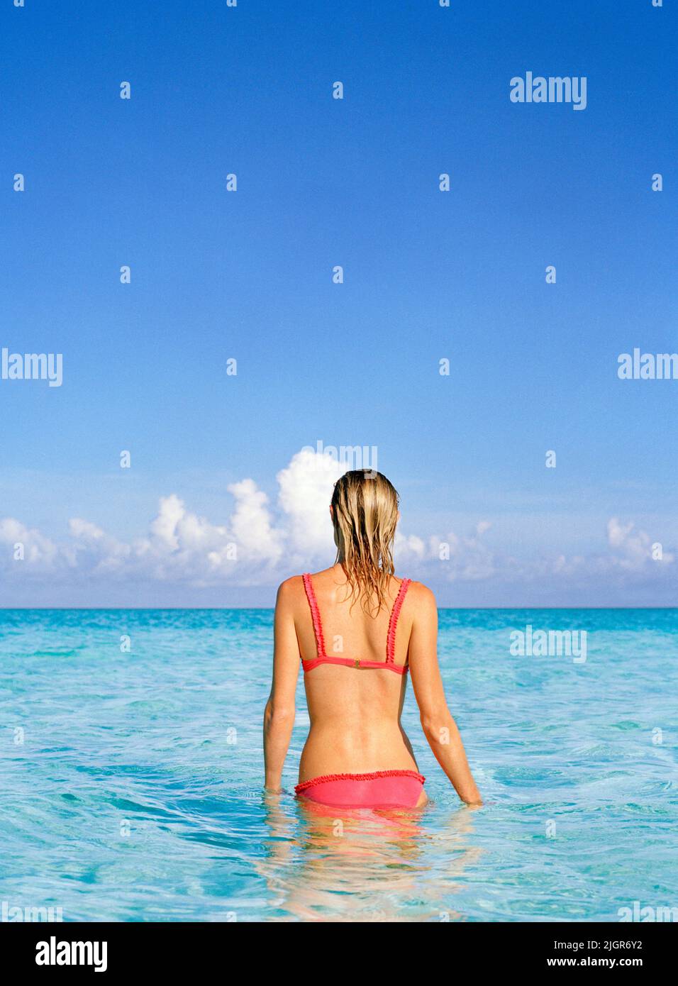 Back view of woman in ocean , Providenciales, Turks and Caicos Stock Photo