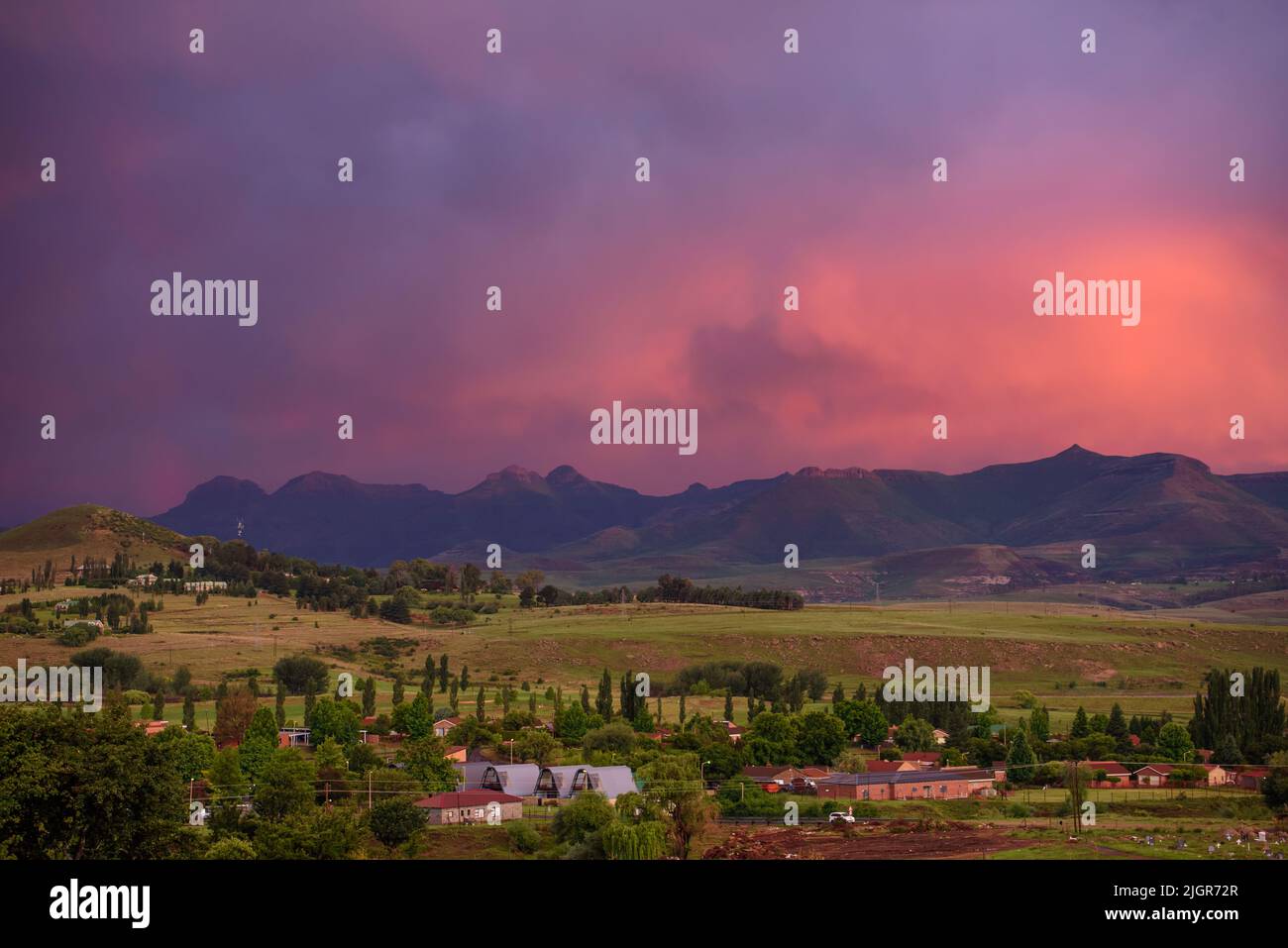 A view of the mountains at sunset from Clarens town in the Free State, South Africa, near the Golden Gate Highlands National Park Stock Photo