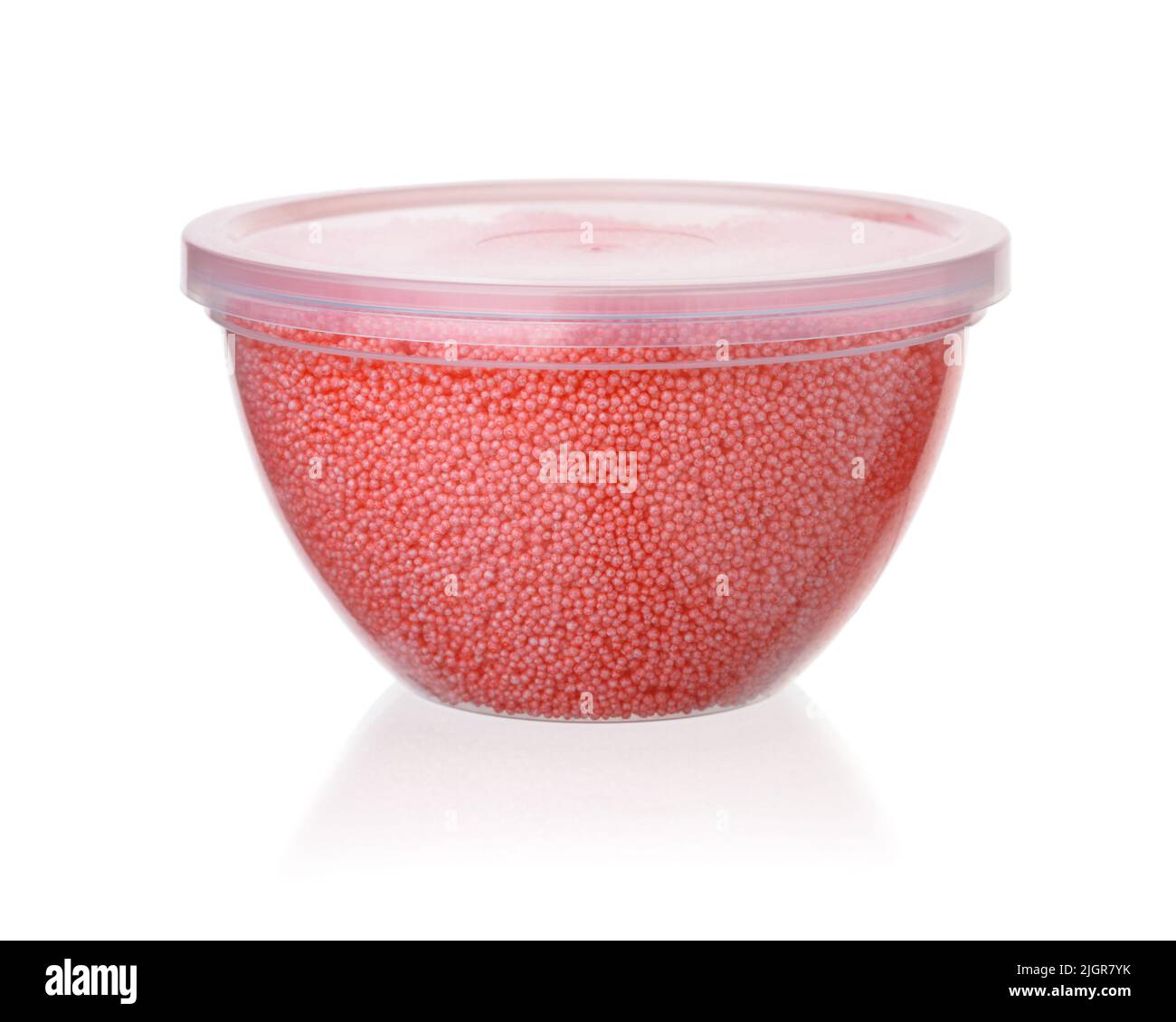 Red modeling foam beads clay in plastic container isolated on white Stock Photo