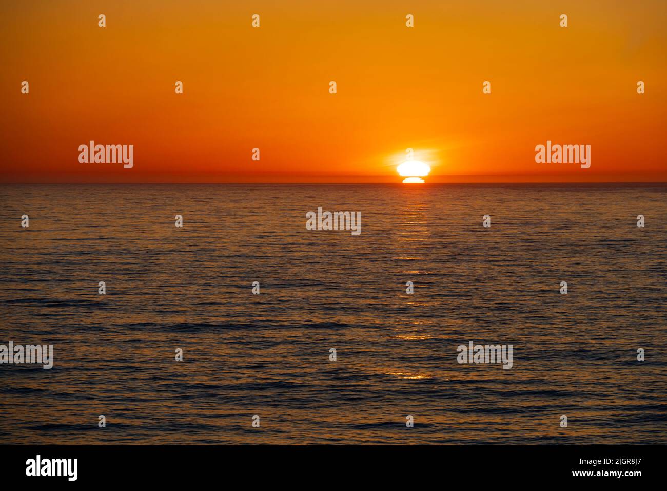 Sunset sunrise over the ocean waves. Generic. Stock Photo