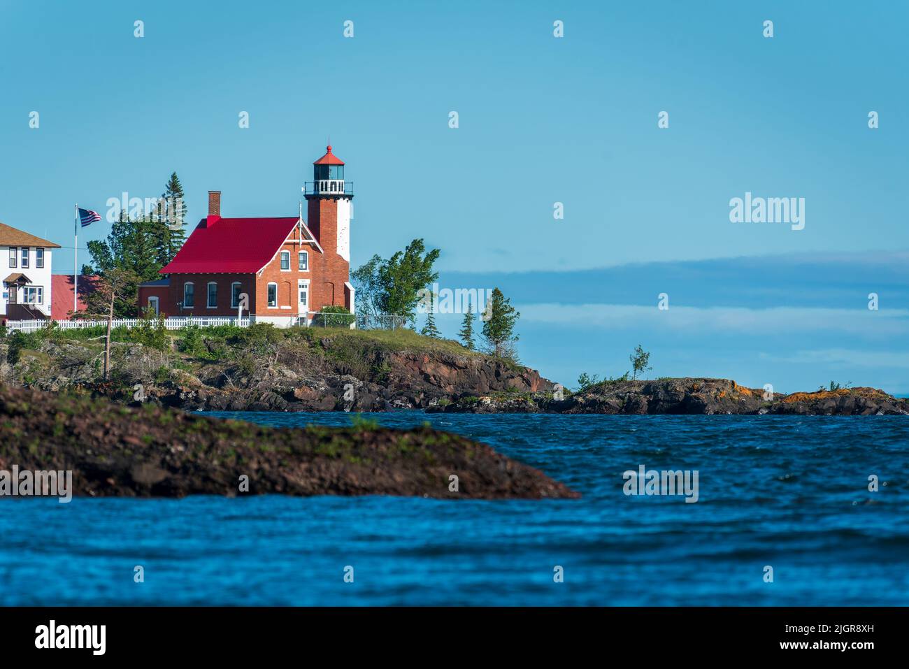Eagle Harbor Lighthouse stands above a rocky entrance to Eagle Harbor