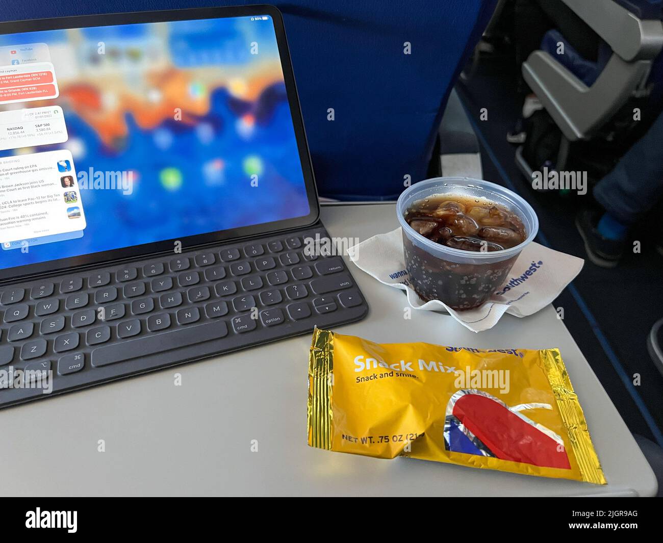 Orlando, FL USA - July 1, 2022: A drink and snack in front of a computer from a flight on Southwest Airlines Co. Stock Photo