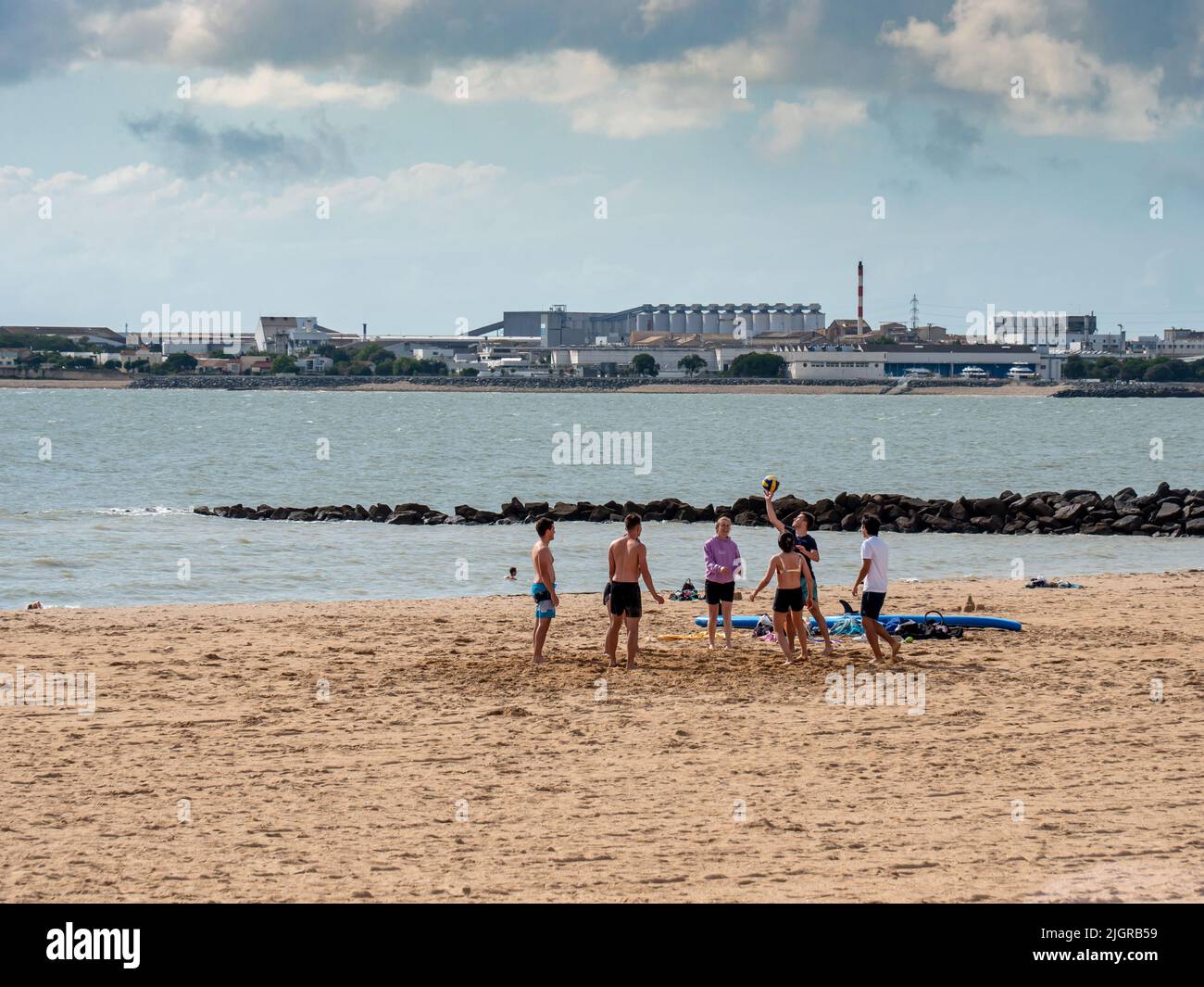 La Rochelle, France July 2022. Beach volleyball - a group of young people playing volleyball on the beach in La Rochelle, smiles on their faces, relax Stock Photo