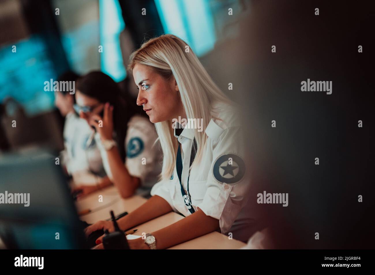 Female security operator working in a data system control room offices ...