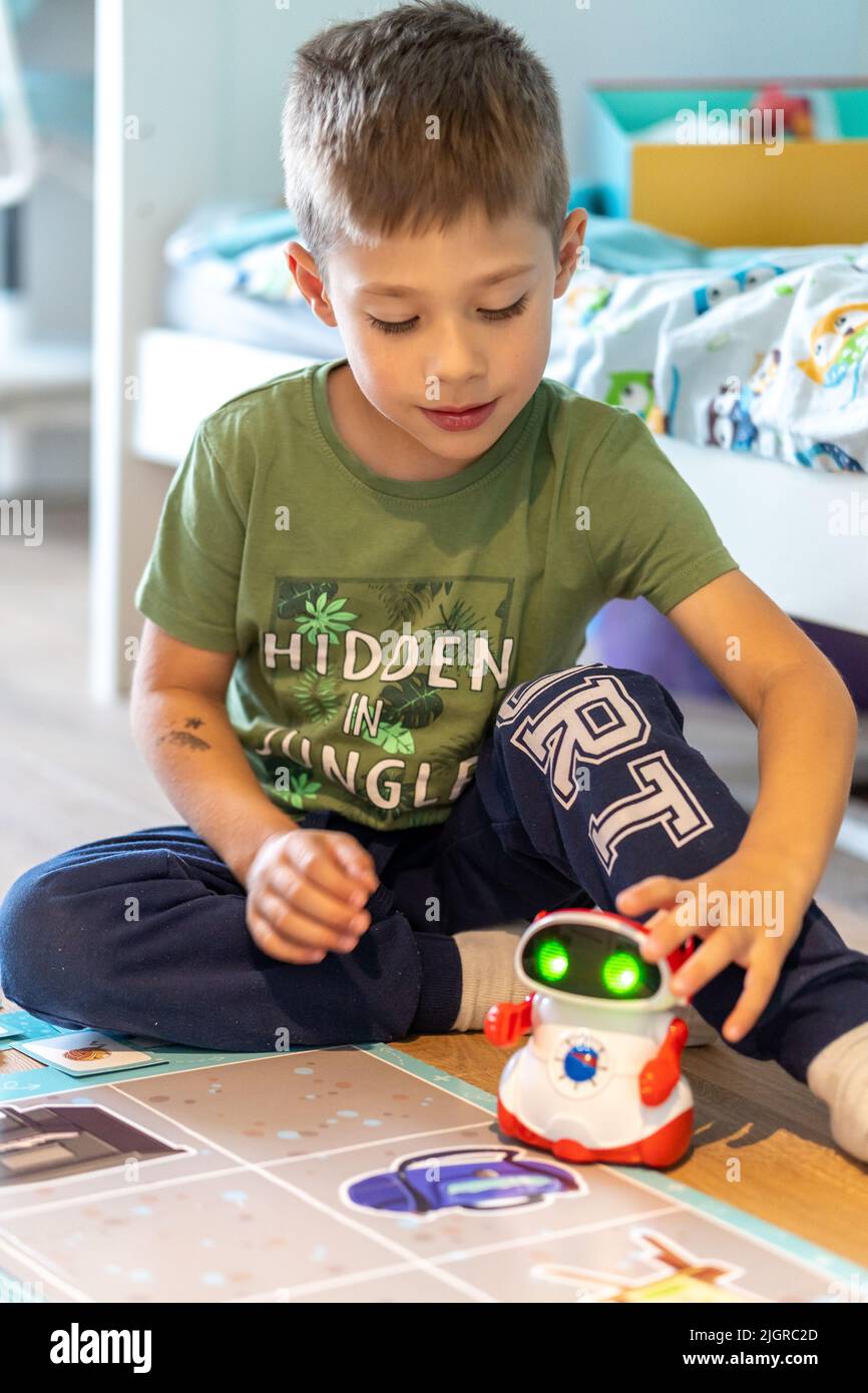 A vertical shot of a young boy playing with a Super Doc educational robot  by Clementoni brand Stock Photo - Alamy