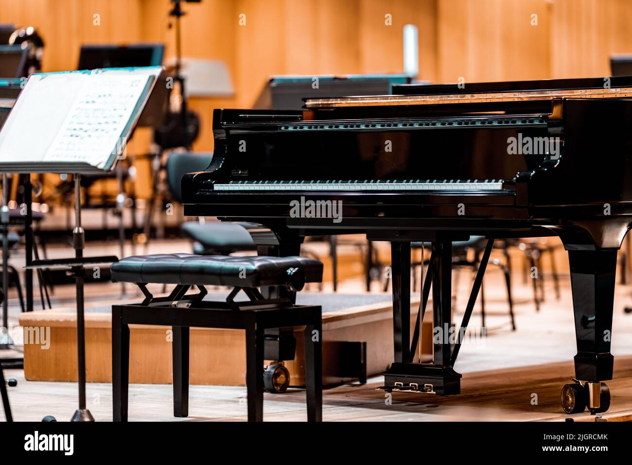 a piano on the Philharmonic stage among other musical instruments Stock