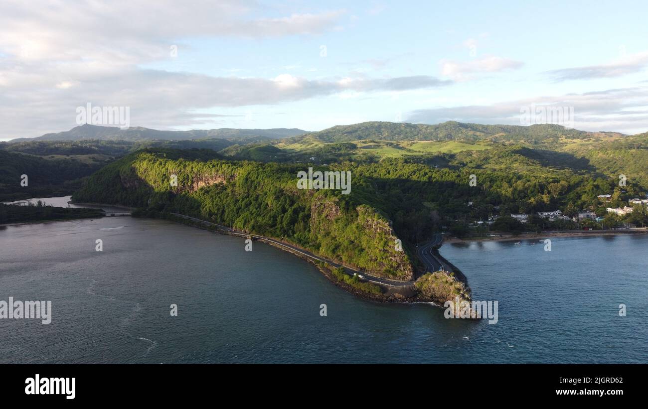 An aerial view of lush green island on blue cloudy sky background Stock ...