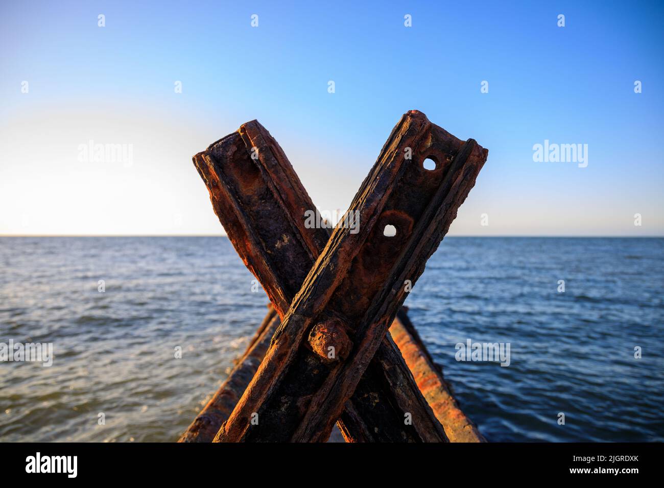 A closeup of rusty metal pieces on the sea in Aberaeron Breakwater Stock Photo