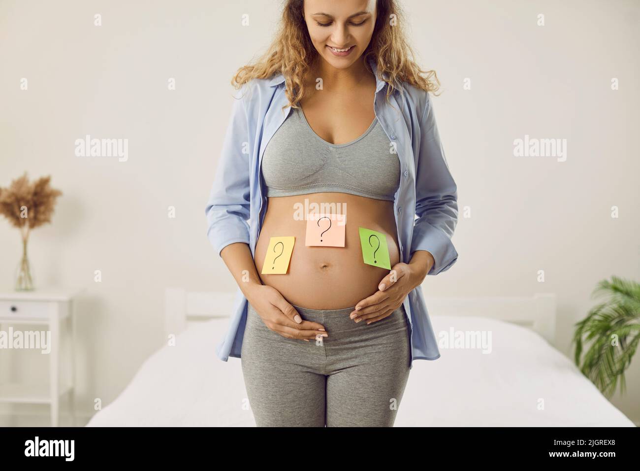 Happy pregnant woman wonder about baby gender Stock Photo