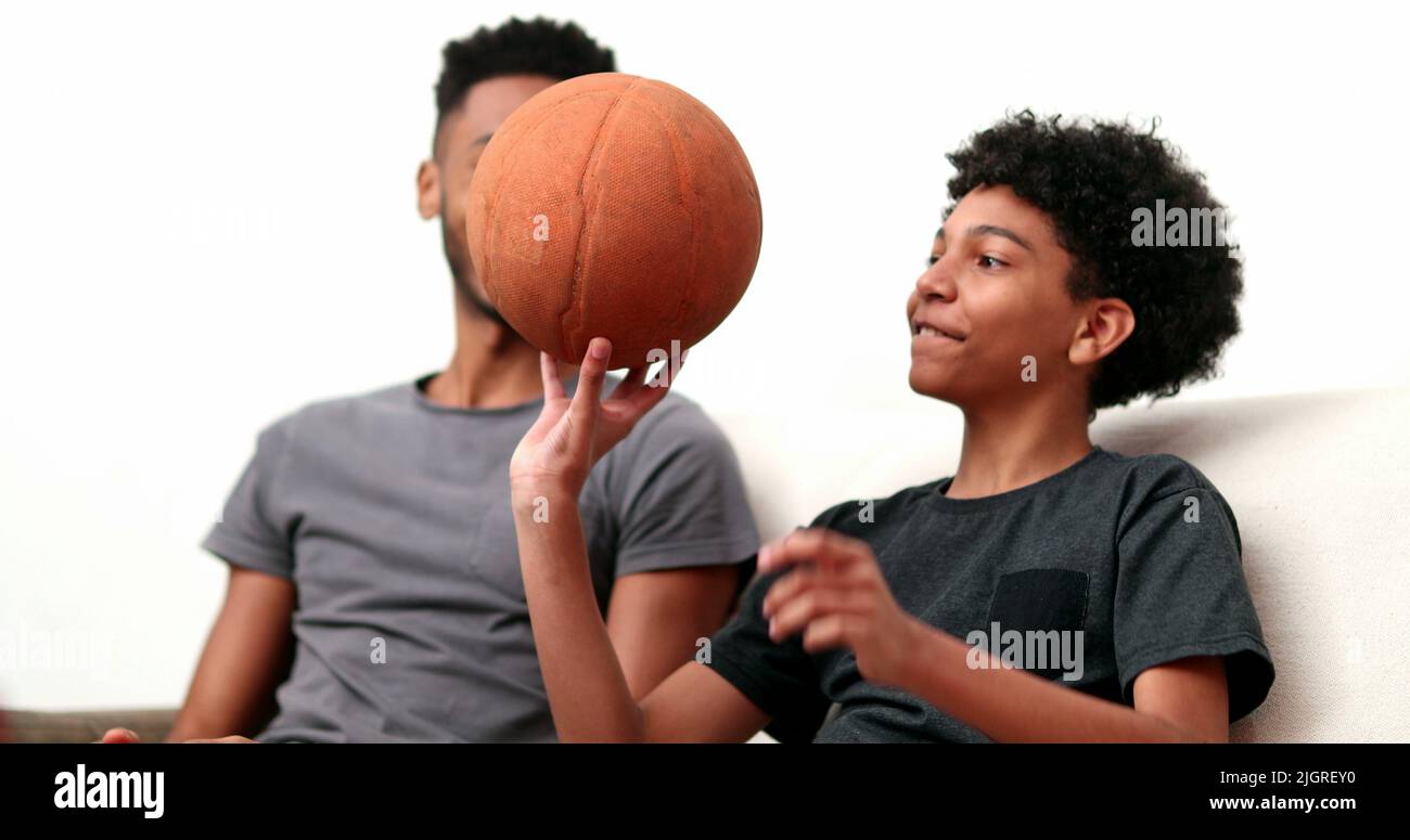 Brothers bonding together with basketball. Mixed race, black ethnicity
