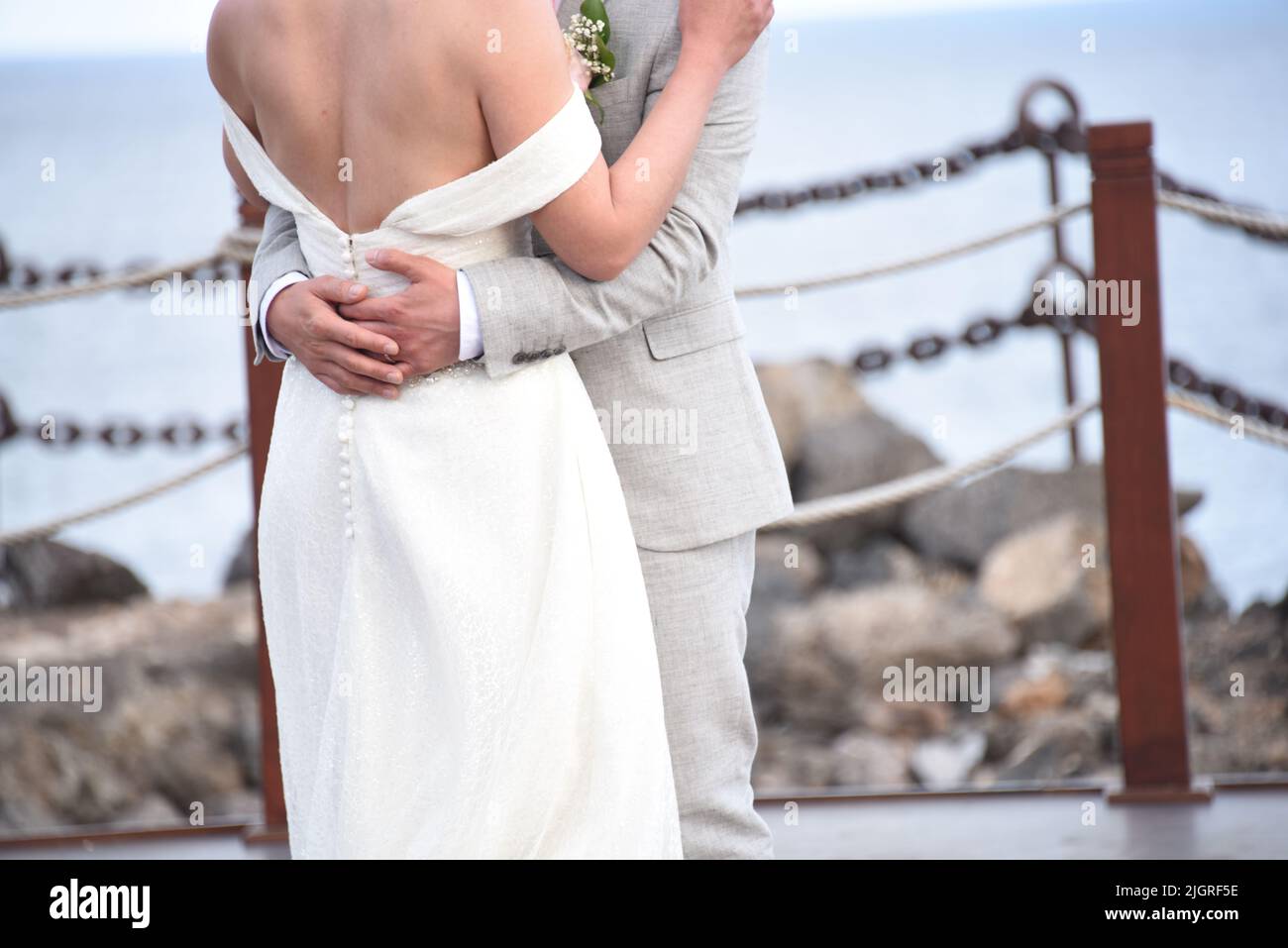 A bridal couple embracing each other on the wooden bridge Stock Photo ...