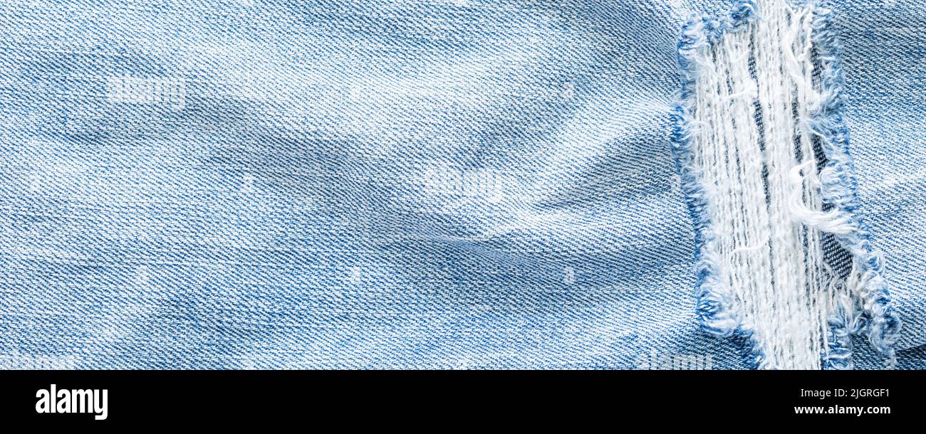 Light blue torn jeans texture background Stock Photo