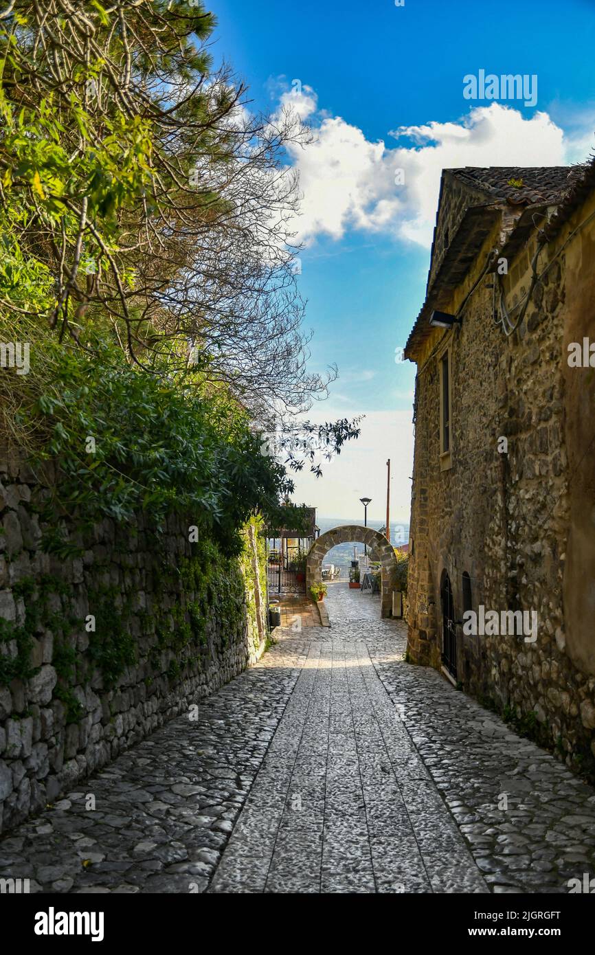 A narrow street among the stone houses of the oldest district of the city of Caserta under a clear sky Stock Photo