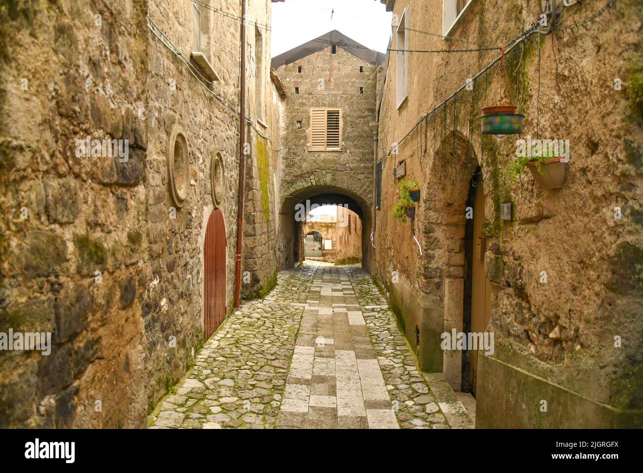 A narrow street among the stone houses of an old district of the city of Caserta Stock Photo