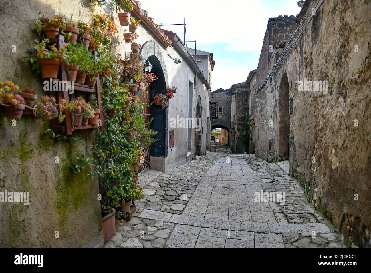 A narrow street among the old stone houses and fences of the oldest district of the city of Caserta Stock Photo
